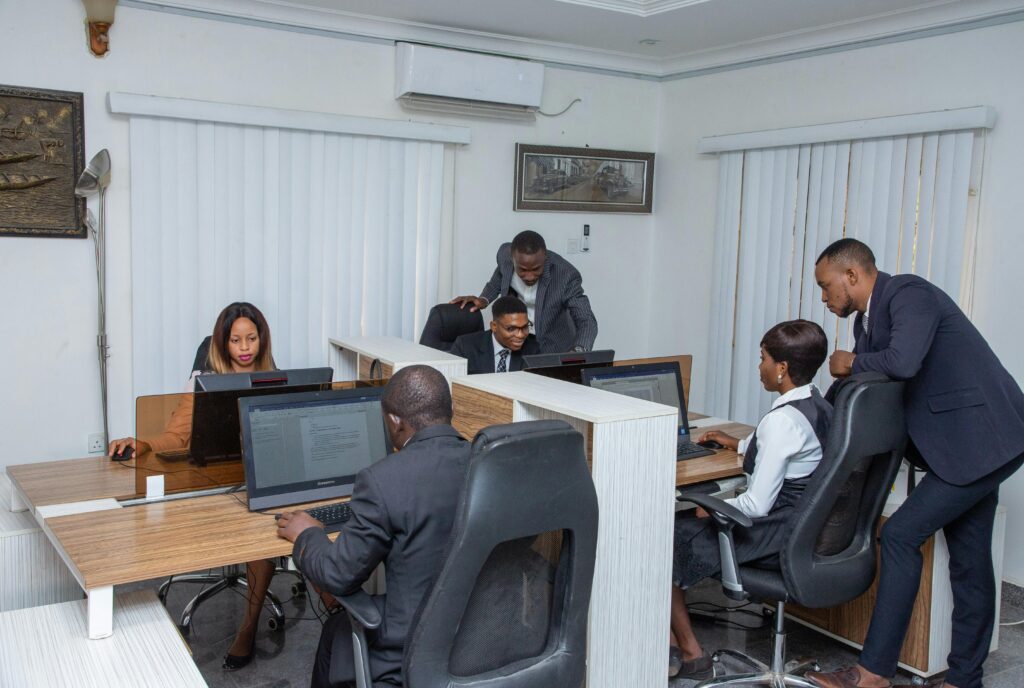 A group of professionals working together in a modern office setting, emphasizing teamwork and productivity.